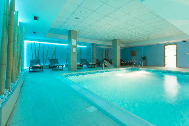 istock Indoor swimming pool in hotel spa center 878012520