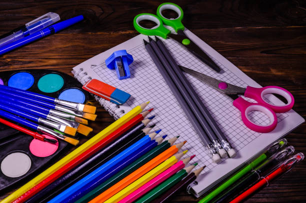 istock Set of different school stationeries. Notepad, scissors, pensils, paints, paintbrushes on wooden desk. Back to school 878016238