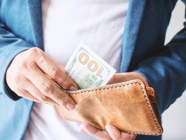 istock Close up man hands with wallet and Dollar money 878016252