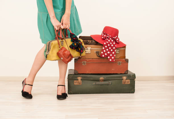 istock Woman Standing Beside Suitcases 878016294