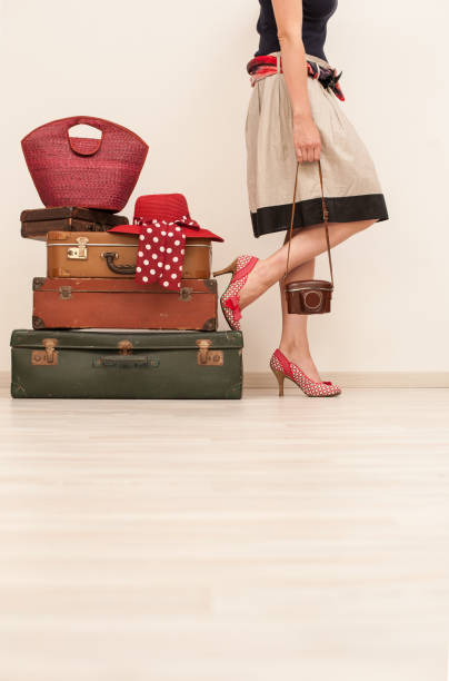 istock Woman Standing Beside Suitcases 878016296
