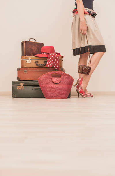 istock Woman Standing Beside Suitcases 878016298