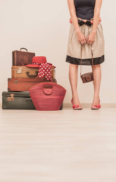 istock Woman Standing Beside Suitcases 878016306