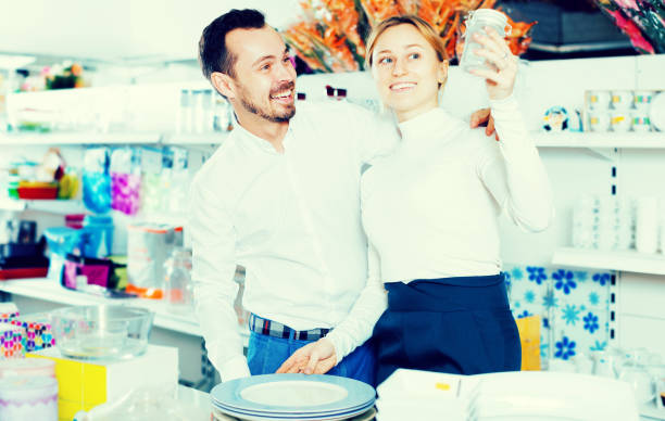 istock Couple choosing new crockery in dinnerware store 878016540