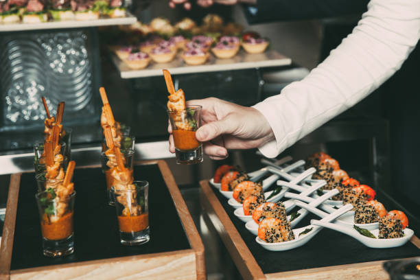 istock Cropped Woman Taking Snack from Buffet Table 878016796