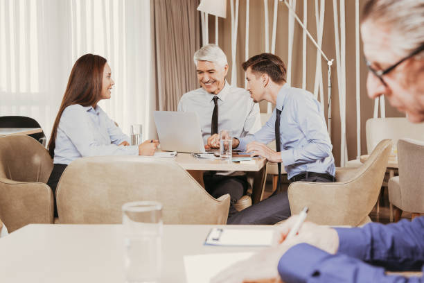 istock Business Team and Senior Man Working in Cafe 878016802