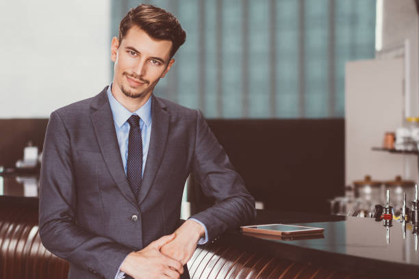 istock Friendly Middle-aged Businessman at Cafe Counter 878016832