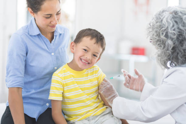 istock Happy little boy receives a vaccination 878019164