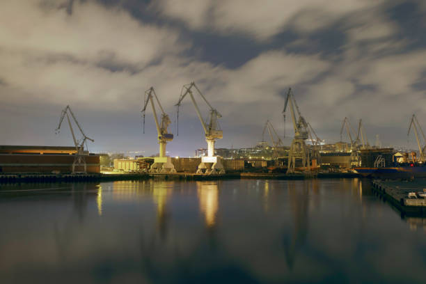 istock Monumental Cranes at sunrise in Shipyard. 878022242
