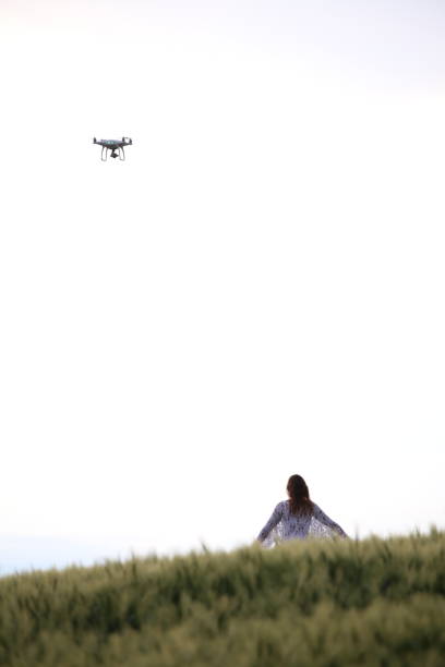 istock Woman On Field Against Clear Sky 878025586