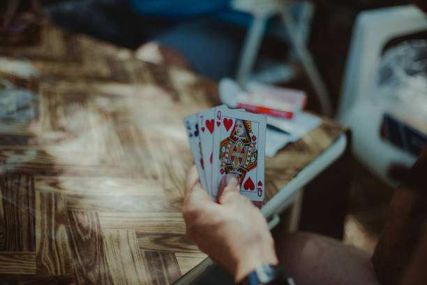 istock Cropped Hand Of Man Playing Cards 878031610