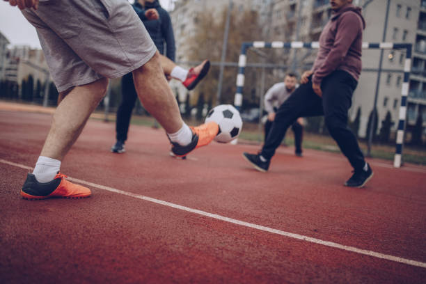 istock Male Friends Playing Soccer 878043176
