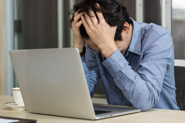 istock Business man are stressed sitting at office desk in office 878045902