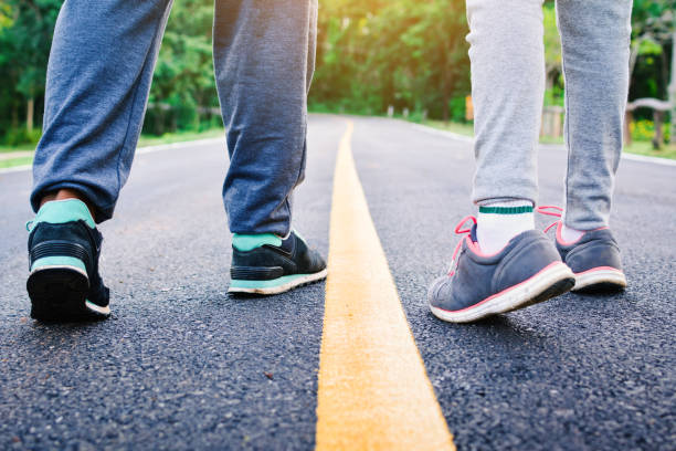 istock Low Section Of People Walking On Road 878045996