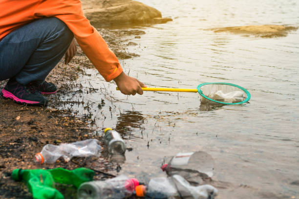 istock Group of kids volunteer help garbage collection charity environment. 878046224