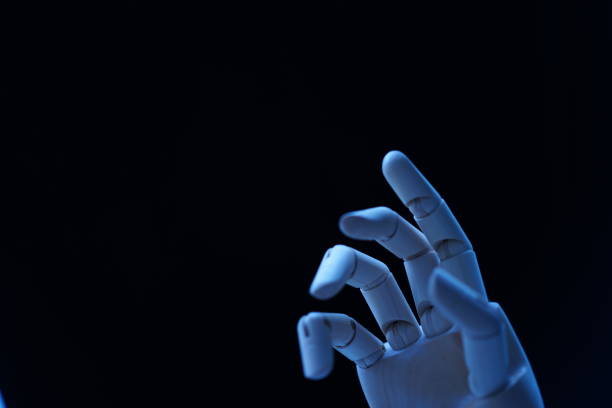 istock Figurine Hand Against Black Background 878052958