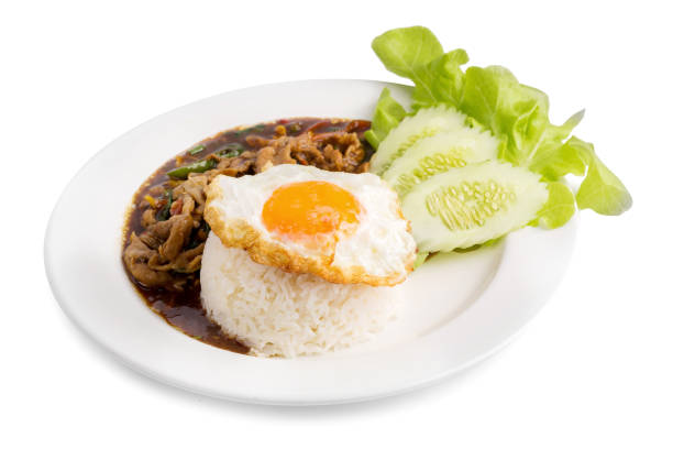 Holy Basil Fried Rice with pork and Fried Egg Sunny side Up isolated on white background.