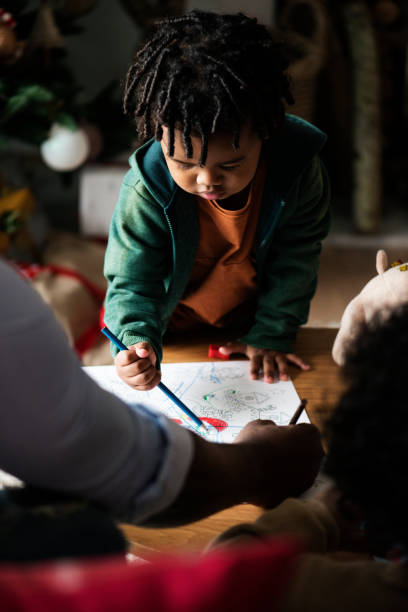 istock Kids enjoying the coloring book 878069962