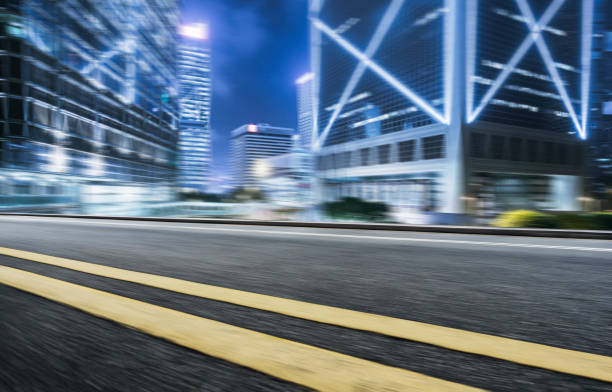 istock empty highway against modern illuminated skyscrapers of Hong Kong 878084814