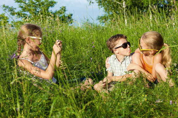 istock Three happy children  playing in the park at the day time. 878090780