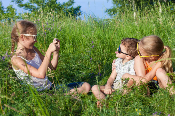 istock Three happy children  playing in the park at the day time. 878091106