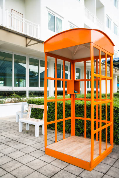 Orange telephone box with blue telephone