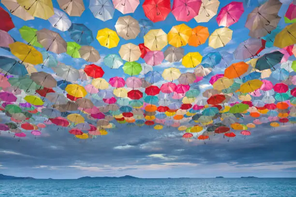 Photo of Abstract design of umbrellas flying in the sky