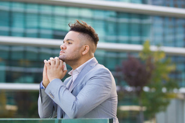 istock Pensive successful businessman walking in city 878099450