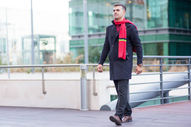 istock Confident businessman walking along transition 878116028