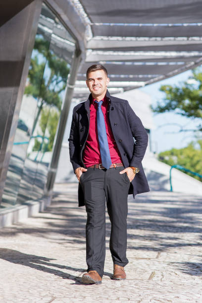 istock Happy businessman walking at office building 878116032