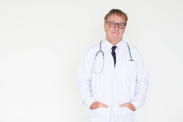 istock Content Mature Doctor with Hands in Pockets 878119082