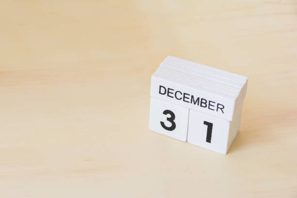 istock 31 December wooden cube calendar on wood surface with copy space 878122388