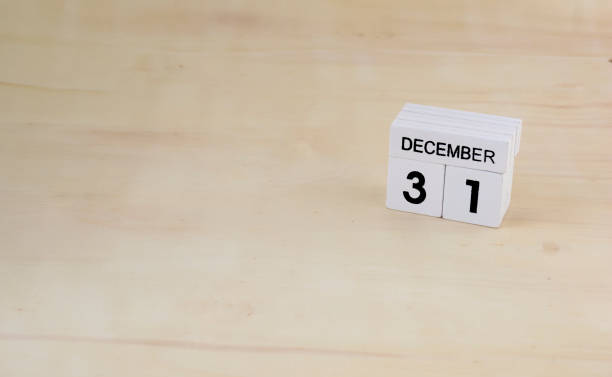 istock 31 December wooden cube calendar on wood surface with copy space 878122408