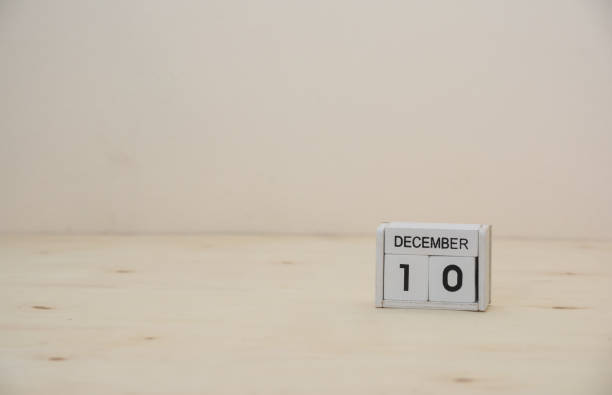 istock 10 december wooden cube calendar on wood surface with copy space 878124704