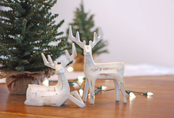 istock Deer Christmas decorations with lights and trees on table 878125112