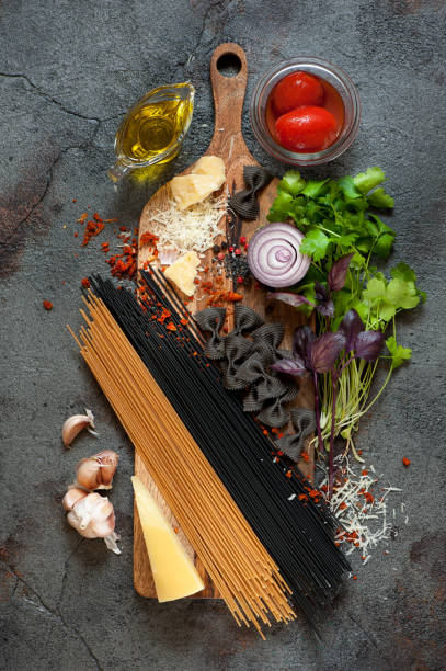 istock Spaghetti pasta ingredients. Tomatoes, parmesan cheese, garlic, herbs and spices 878137440