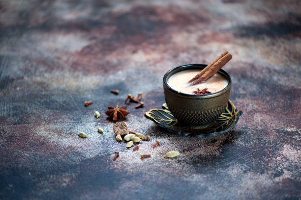 istock Indian masalachai masala tea cup on the old kitchen table 878140534