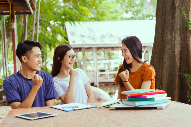 istock Student university success project concept, students asian working complete and finish job happy feeling with friends smiling at campus high school college 878140554