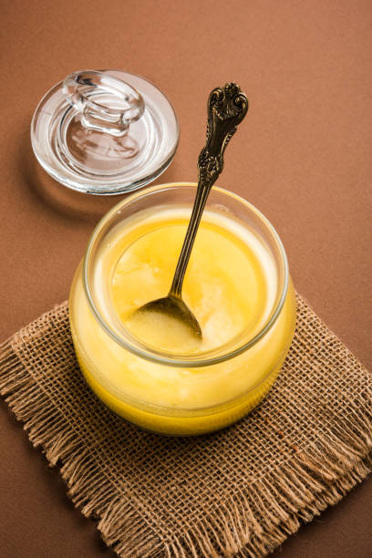 istock Desi Pure Ghee or clarified butter in glass or Copper container with spoon, selective focus 878141104