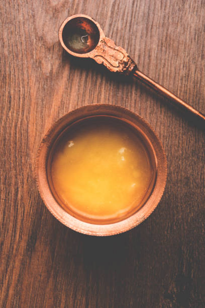 istock Desi Pure Ghee or clarified butter in glass or Copper container with spoon, selective focus 878143522