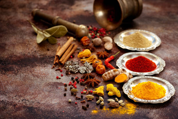 istock Spices and herbs in silver bowls and old mortar on a rusty old background. 878143946