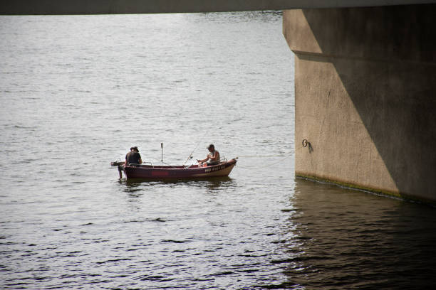 Small wooden canoe floating on the calm waters of Guayas River near Santay Island, creating a serene scene of river navigation and cultural exploration