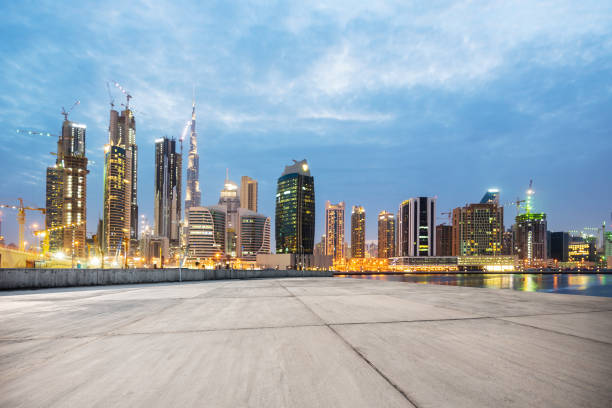 istock empty concrete floor with modern buildings at twilight 878146540