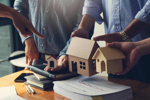istock Engineer and Architect concept, Engineer Architects office team working and discussing house model, Vintage Effect 878146728