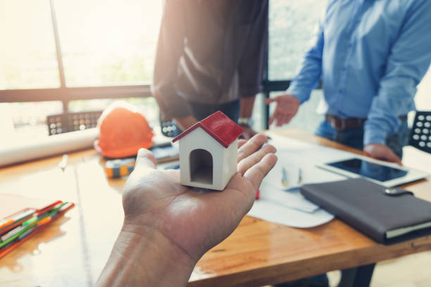 istock Engineer and Architect concept, Engineer Architects office team working and discussing house plan  model, Vintage Effect 878146982