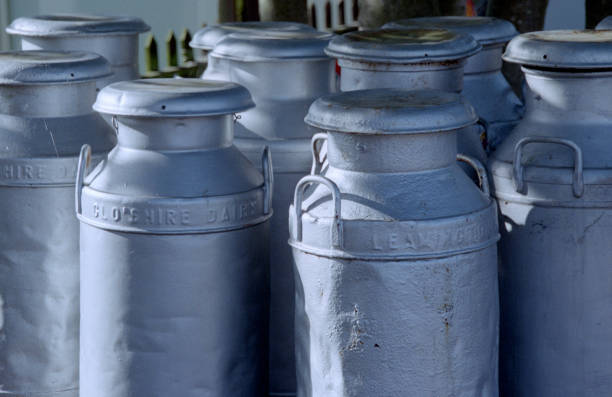 old rusty milk cans in front of grocer's shop
