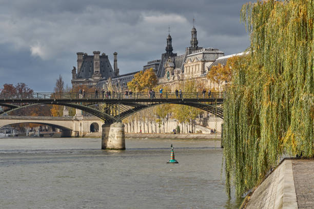 Paris, Ile-de-France FRANCE - November 19, 2017. Pont des Arts Bridge and Louvre Museum from the Cité Island with autumn colors