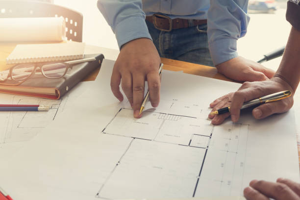 istock Engineer and Architect concept, Engineer Architects office team working and discussing house plan  model, Vintage Effect 878150428