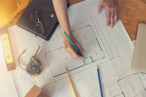 istock Engineer and Architect concept, Engineer Architects office team working with blueprints, Vintage Effect 878152588