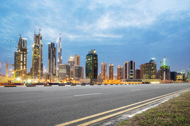 istock empty asphalt road with modern buildings at twilight 878152592
